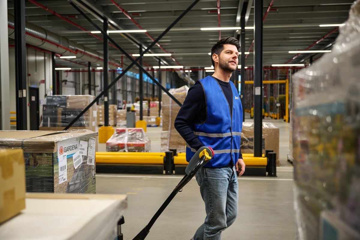 Employee with a hand pallet truck.