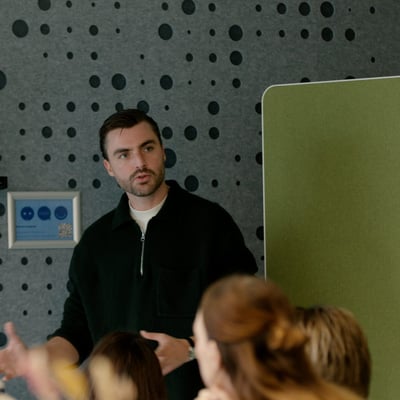 A man giving a presentation to an audience and interacting with the group.