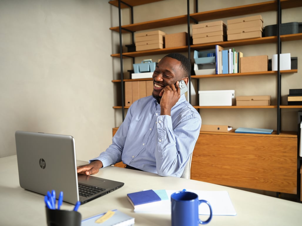 man-calling-at-desk