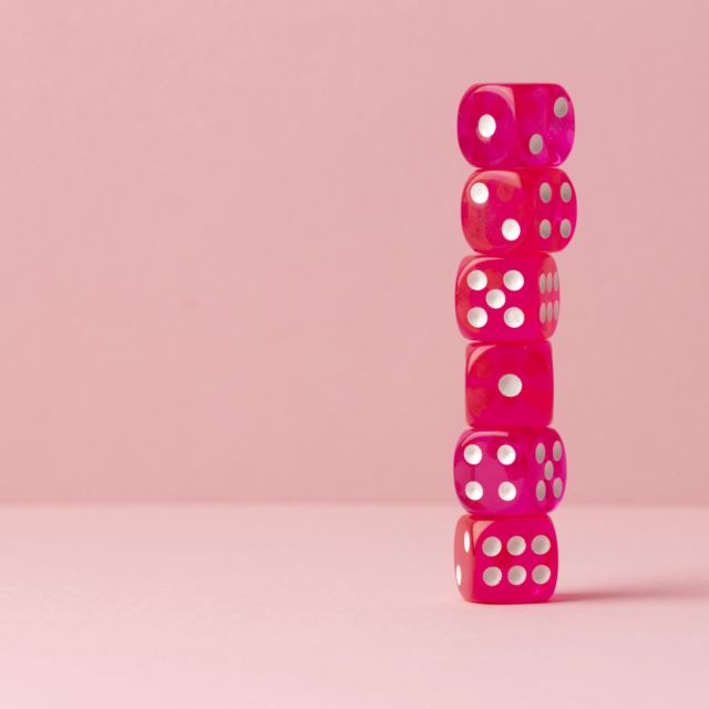 stacked-pink-dices-pink-background.jpg